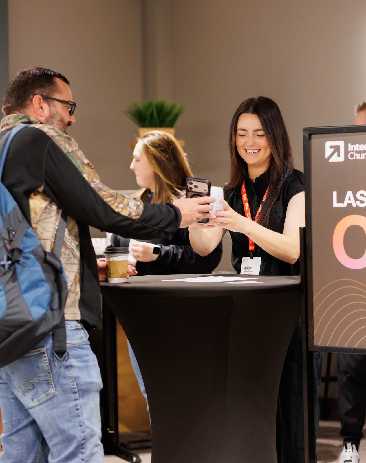 A guest checking in at the conference registration table