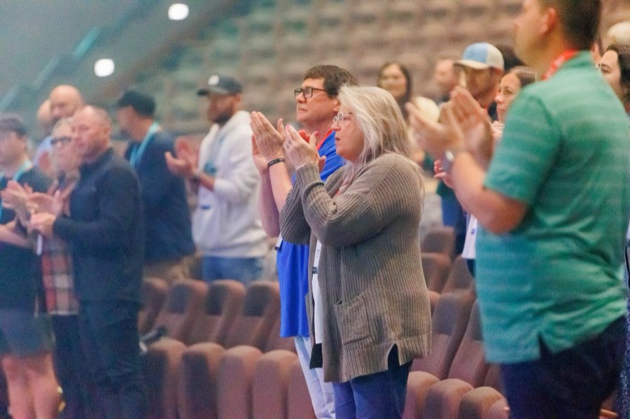 Leaders applauding in the auditorium